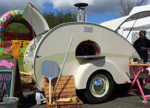 The Tinderbox trailer at a festival with stone baked pizza sign
