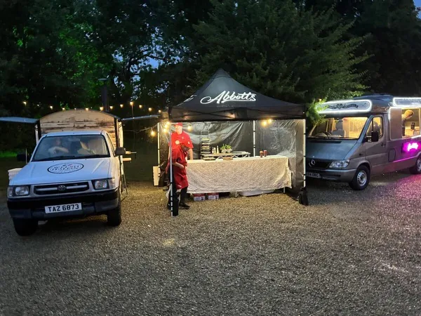 Abbotts Events full setup at night with gazebo and festoon lights